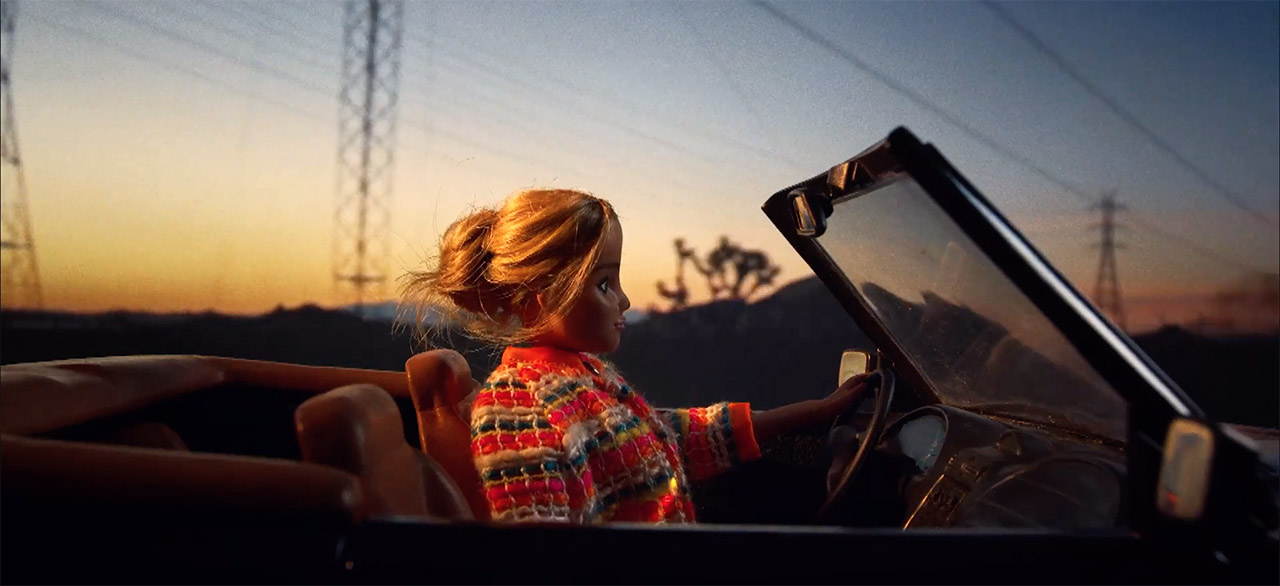 Barbie type doll driving convertible